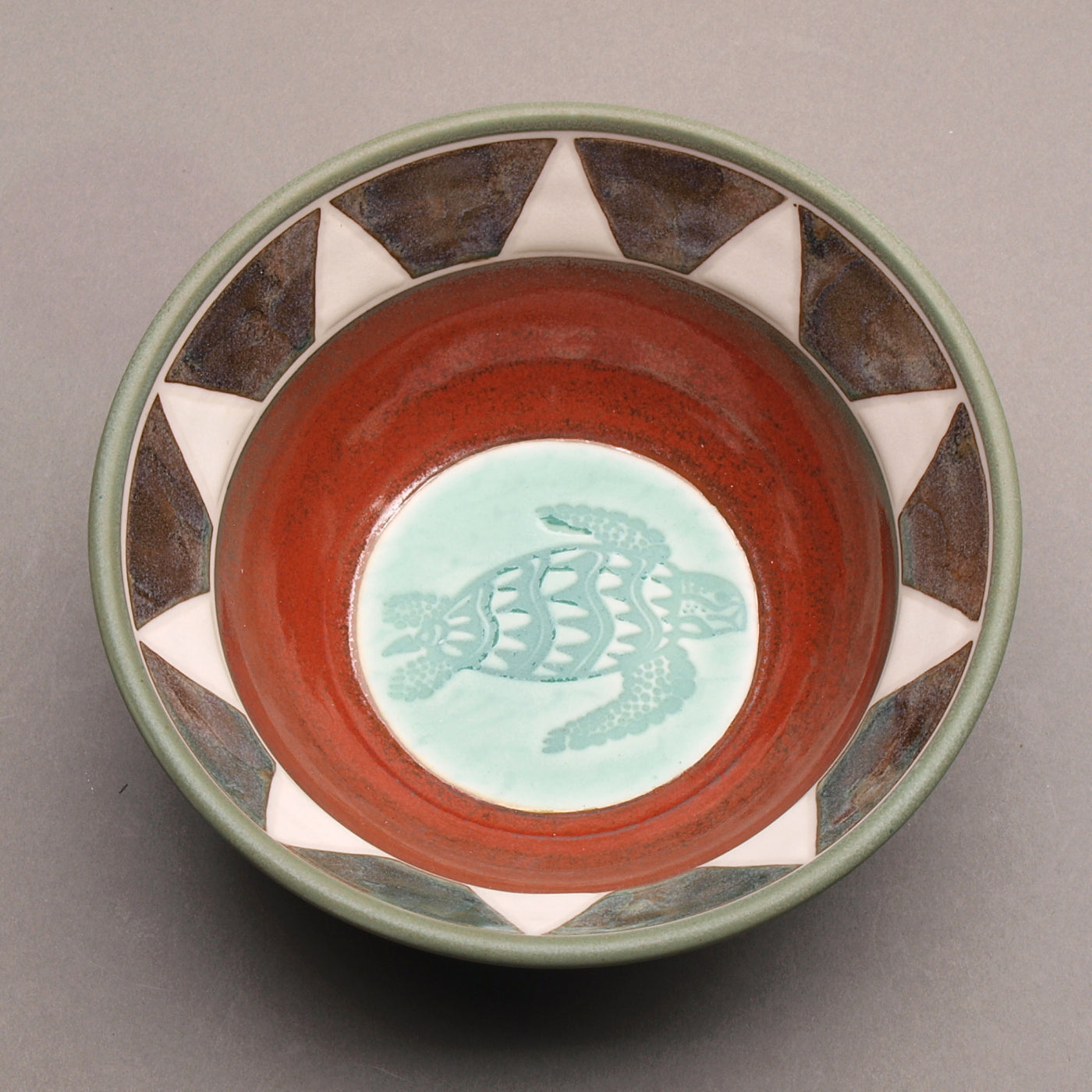 Ceramic Porcelain Pottery Handcrafted Sea Turtle Bowl, Southwestern Style Ceramic, Iron Red Ohata with Turquoise Center, Sage green exterior. Tribal Triangle Border, White & Iron Blue