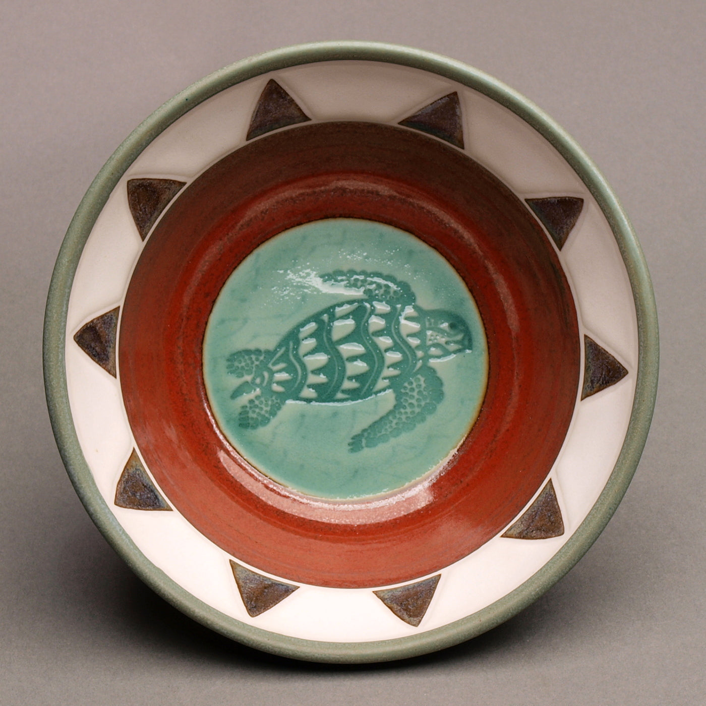 Ceramic Porcelain Pottery Handcrafted Sea Turtle Bowl, Southwestern Style Ceramic, Iron Red Ohata with Turquoise Center, Sage green exterior. Tribal Triangle Border, 8-Point Sun Design
