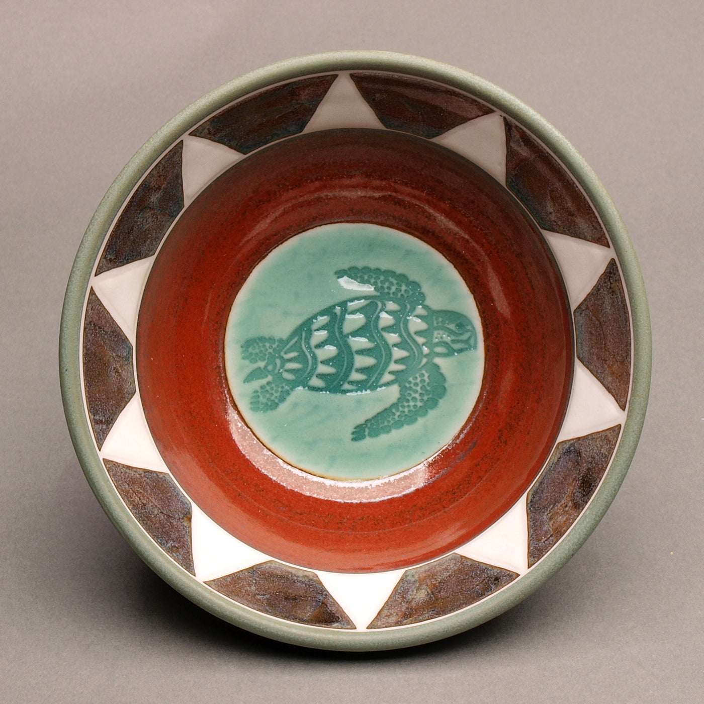 Ceramic Porcelain Pottery Handcrafted Sea Turtle Bowl, Southwestern Style Ceramic, Iron Red Ohata with Turquoise Center, Sage green exterior. Tribal Triangle Border, White & Iron Blue